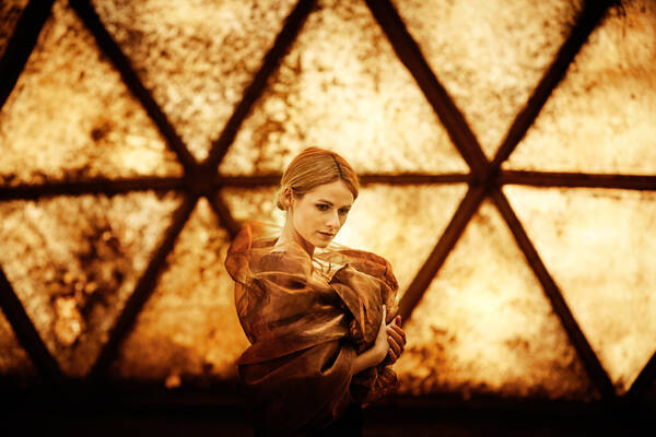 Portrait einer jungen Frau im Klangdom. Die Frau ist in seidene Tücher gehüllt.