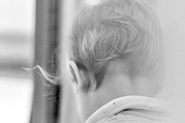 Ein Kind beim Spiel von hinten eine Haarsträhne flattert. Schwarz-Weiß