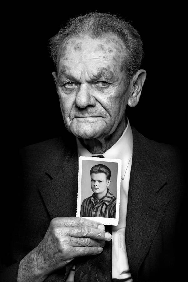 Portrait eines alten Mannes, der ein Bild von sich in der Jugend hält. Schwarz-Weiß.